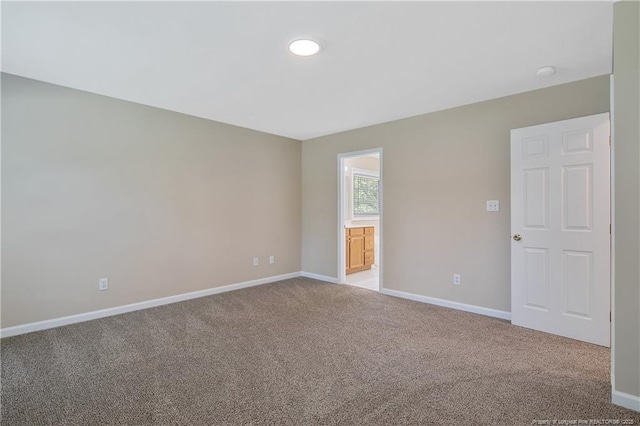 spare room with recessed lighting, baseboards, and carpet