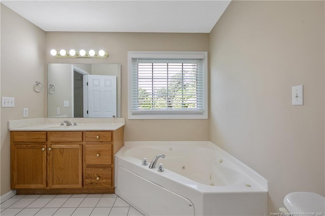 bathroom featuring a jetted tub, tile patterned floors, toilet, and vanity
