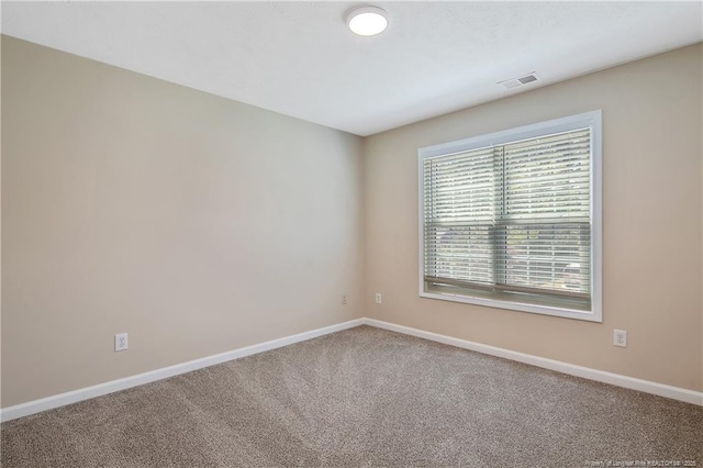 carpeted empty room with baseboards and visible vents