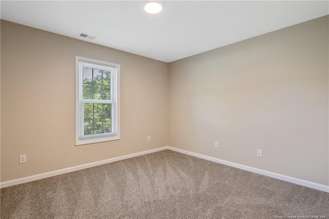 unfurnished room with baseboards, carpet flooring, and visible vents