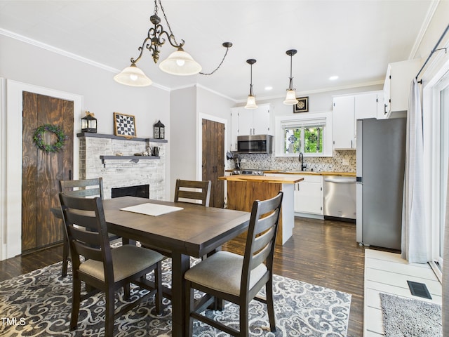 3609 Creekridge Country Rd, Randleman, NC 27317 - dining area with dark wood-style flooring, visible vents, a fireplace, ornamental molding, and recessed lighting