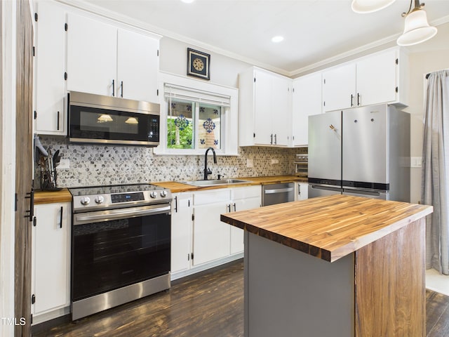 3609 Creekridge Country Rd, Randleman, NC 27317 - kitchen with decorative backsplash, dark wood-style flooring, appliances with stainless steel finishes, a sink, and butcher block counters