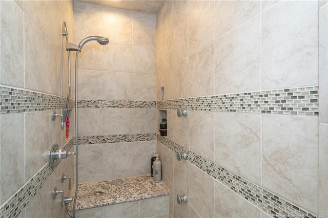 full bath featuring tiled shower