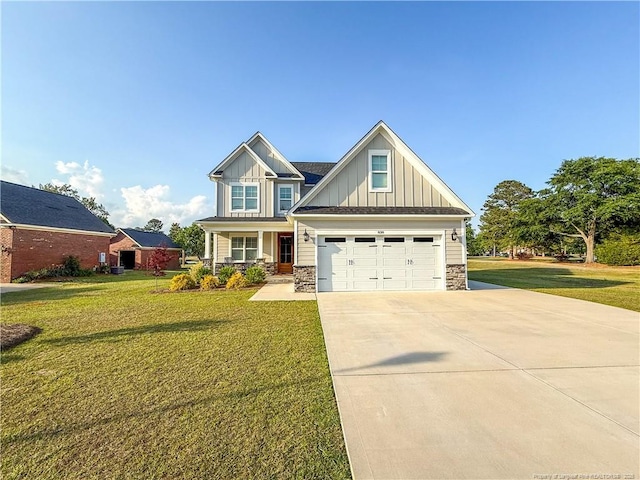 craftsman house with a front lawn, board and batten siding, stone siding, and concrete driveway