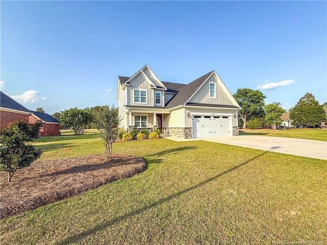 craftsman-style home featuring board and batten siding, a front yard, driveway, and stone siding