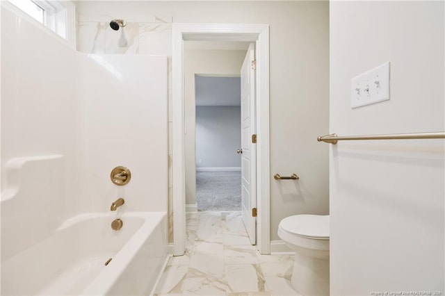 full bathroom featuring toilet, baseboards, tub / shower combination, and marble finish floor