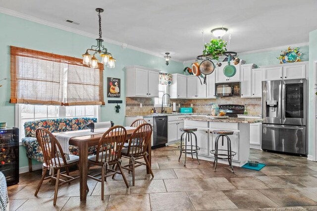 6628 Carriage Crossing Rd, Hope Mills, NC 28348 - dining space with an inviting chandelier, ornamental molding, stone finish flooring, and visible vents