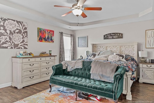 6628 Carriage Crossing Rd, Hope Mills, NC 28348 - bedroom with baseboards, a ceiling fan, a tray ceiling, and dark wood finished floors