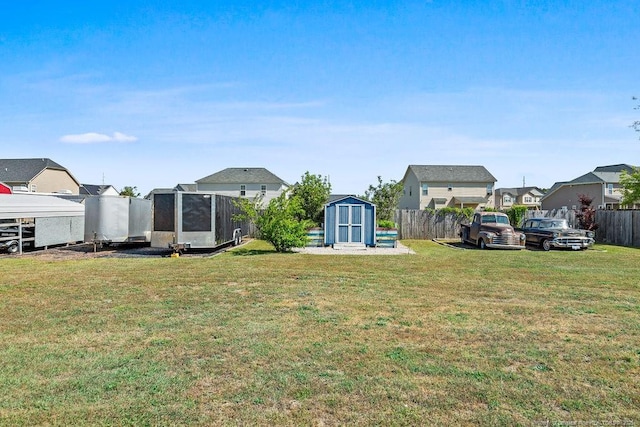 6628 Carriage Crossing Rd, Hope Mills, NC 28348 - view of yard featuring fence, a residential view, an outdoor structure, and a storage unit