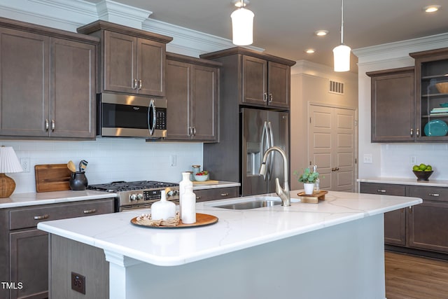 228 Shingle Oak Rd, Wake Forest, NC 27587 - kitchen with appliances with stainless steel finishes, a sink, dark brown cabinetry, tasteful backsplash, and recessed lighting