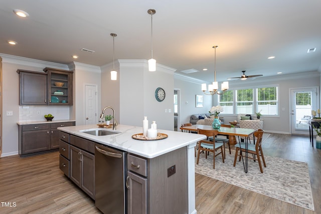 228 Shingle Oak Rd, Wake Forest, NC 27587 - kitchen with stainless steel dishwasher, open floor plan, a sink, light wood-type flooring, and crown molding