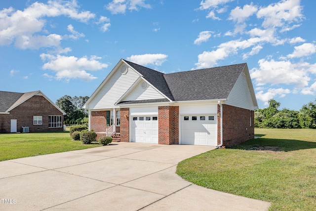 2919 Hayfield Rd, Wade, NC 28395 - view of front of home featuring driveway, an attached garage, brick siding, and a front yard
