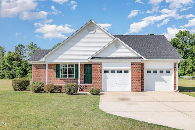 2919 Hayfield Rd, Wade, NC 28395 - view of front facade featuring concrete driveway, a front lawn, brick siding, and an attached garage