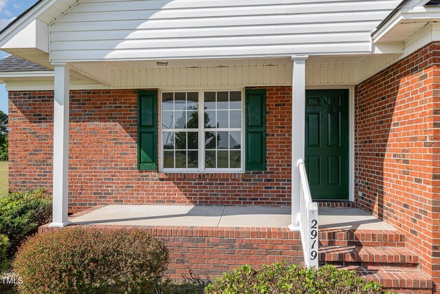 2919 Hayfield Rd, Wade, NC 28395 - entrance to property with a porch and brick siding