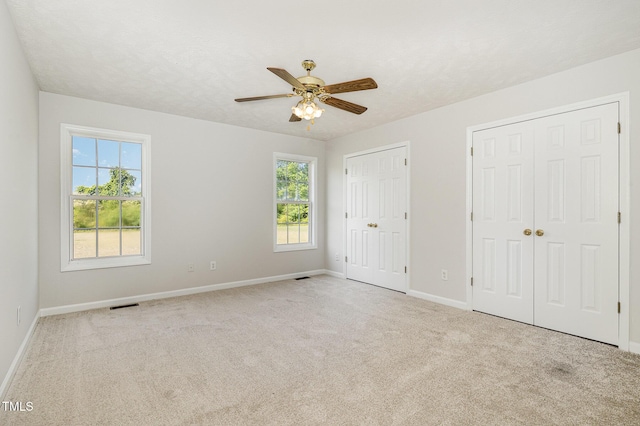 2919 Hayfield Rd, Wade, NC 28395 - unfurnished bedroom with two closets, carpet flooring, baseboards, and visible vents