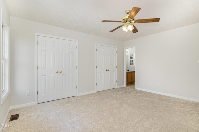 2919 Hayfield Rd, Wade, NC 28395 - unfurnished bedroom featuring baseboards, multiple closets, visible vents, and light colored carpet