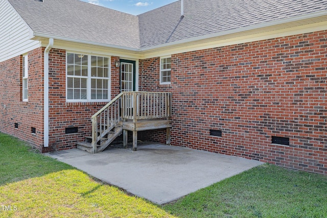 2919 Hayfield Rd, Wade, NC 28395 - view of exterior entry featuring a shingled roof, brick siding, crawl space, and a yard