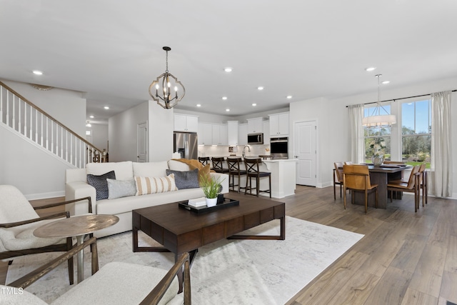 214 Alden Way, Angier, NC 27501 - living area featuring baseboards, recessed lighting, wood finished floors, and a notable chandelier