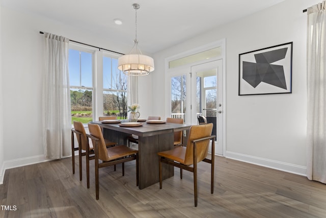 214 Alden Way, Angier, NC 27501 - dining area featuring baseboards, wood finished floors, and a chandelier