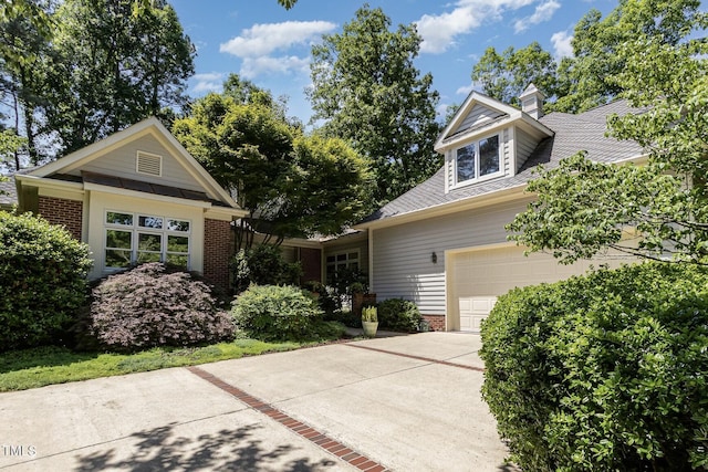 27425 Walker, Chapel Hill, NC 27517 - view of front of house with brick siding, driveway, a chimney, and a garage