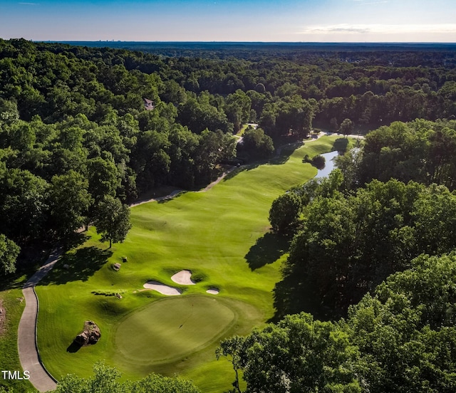 aerial overview of property's location featuring a heavily wooded area and a golf course