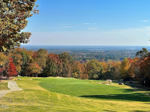 view of community featuring a lawn and golf course view