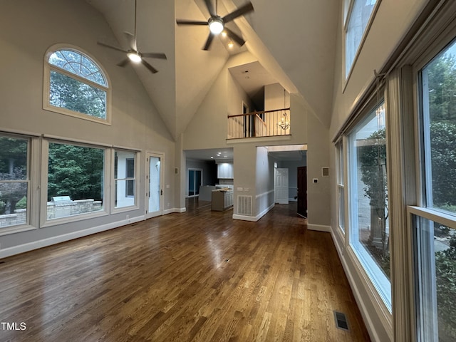90021 Hoey, Chapel Hill, NC 27517 - unfurnished living room with high vaulted ceiling, a ceiling fan, wood finished floors, plenty of natural light, and baseboards