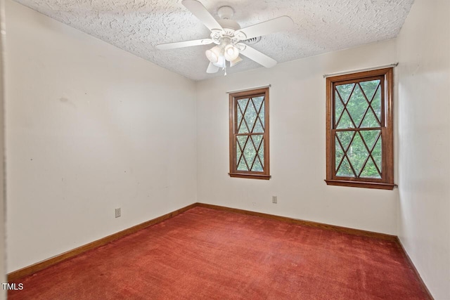 spare room featuring a textured ceiling, ceiling fan, baseboards, and carpet