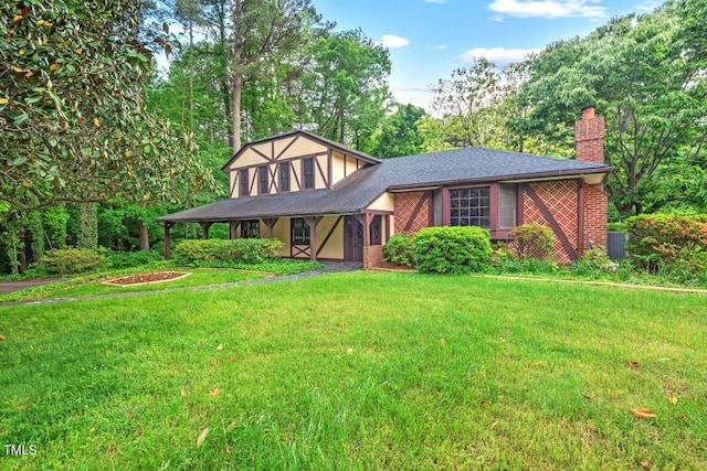 view of front of home featuring a front yard and a chimney