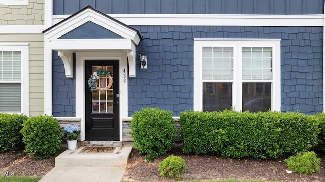 property entrance featuring board and batten siding