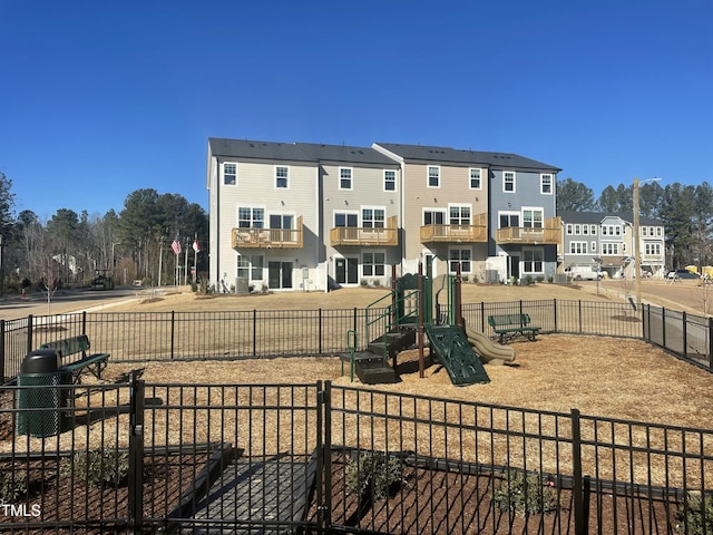 exterior space featuring fence, a residential view, and playground community