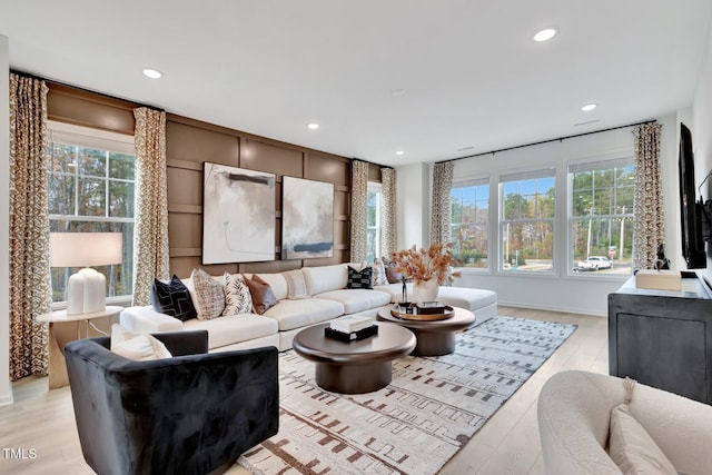 living area featuring plenty of natural light, light wood finished floors, and recessed lighting