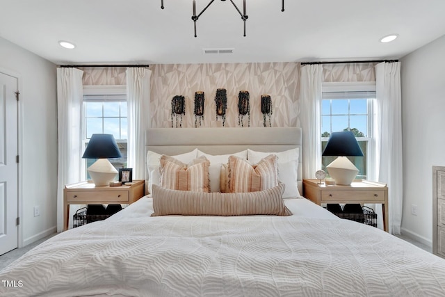 bedroom with baseboards, multiple windows, and visible vents