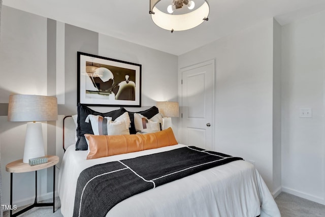 carpeted bedroom featuring baseboards