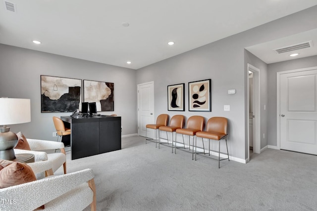 carpeted living area featuring baseboards, recessed lighting, and visible vents