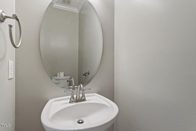 half bathroom featuring a sink