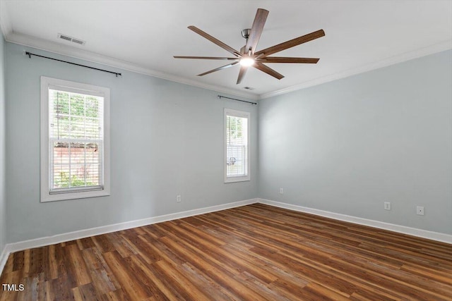 spare room with crown molding, a ceiling fan, baseboards, and dark wood-style floors