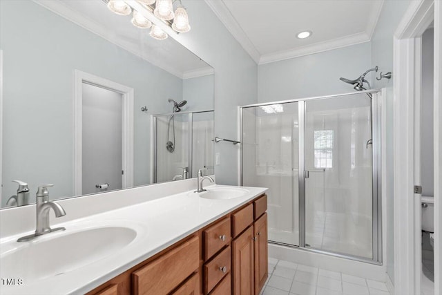 bathroom featuring toilet, ornamental molding, a sink, and a stall shower