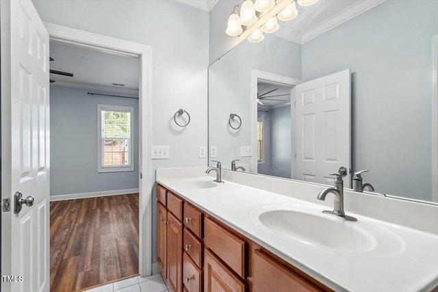 bathroom featuring a sink, ornamental molding, and double vanity