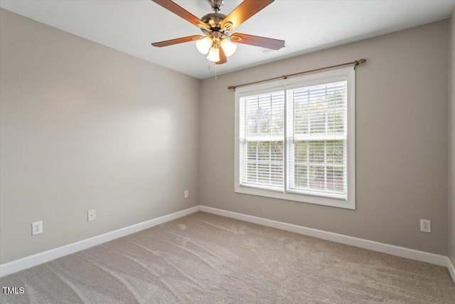 carpeted spare room with baseboards and ceiling fan