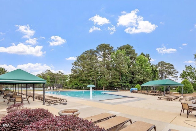 community pool featuring a patio, a gazebo, and fence