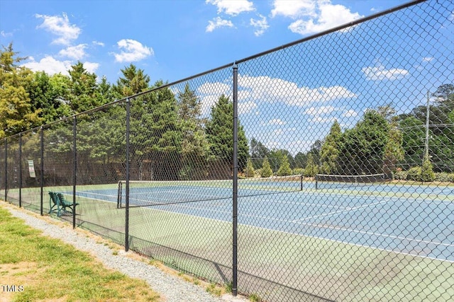 view of sport court featuring fence