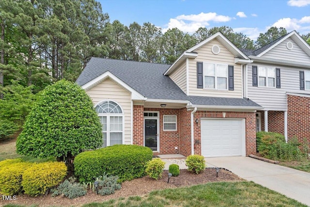 view of front of property with brick siding, an attached garage, roof with shingles, and driveway