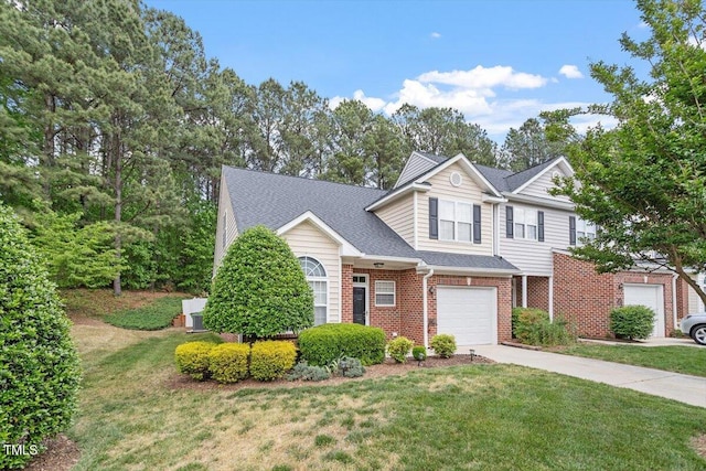 traditional-style home with concrete driveway, brick siding, a front lawn, and a garage