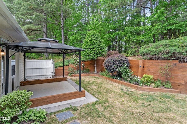 view of yard featuring a gazebo and a fenced backyard