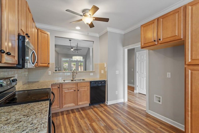 kitchen featuring wood finished floors, ceiling fan, a sink, backsplash, and black appliances
