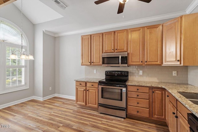kitchen featuring baseboards, appliances with stainless steel finishes, a healthy amount of sunlight, and visible vents