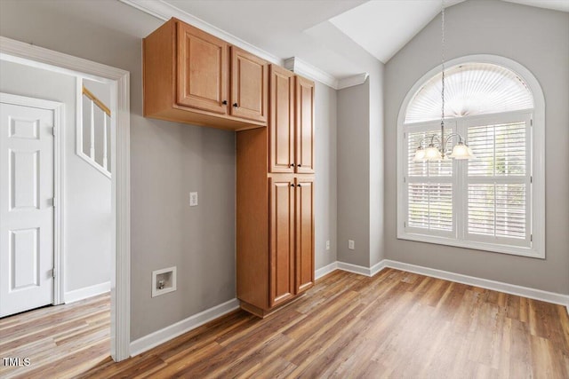interior space featuring baseboards, a chandelier, lofted ceiling, and light wood-type flooring