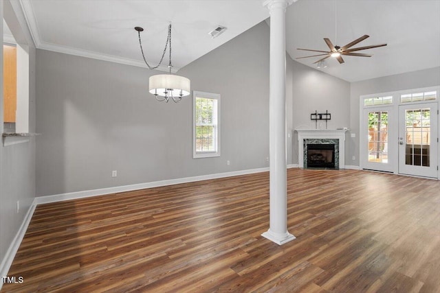 unfurnished living room featuring a ceiling fan, decorative columns, wood finished floors, baseboards, and a premium fireplace