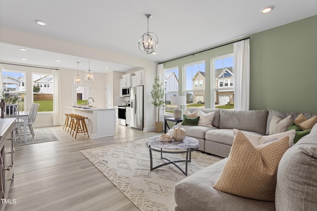 36 Honeydew Way, Clayton, NC 27520 - living area featuring light wood-style floors, an inviting chandelier, and recessed lighting
